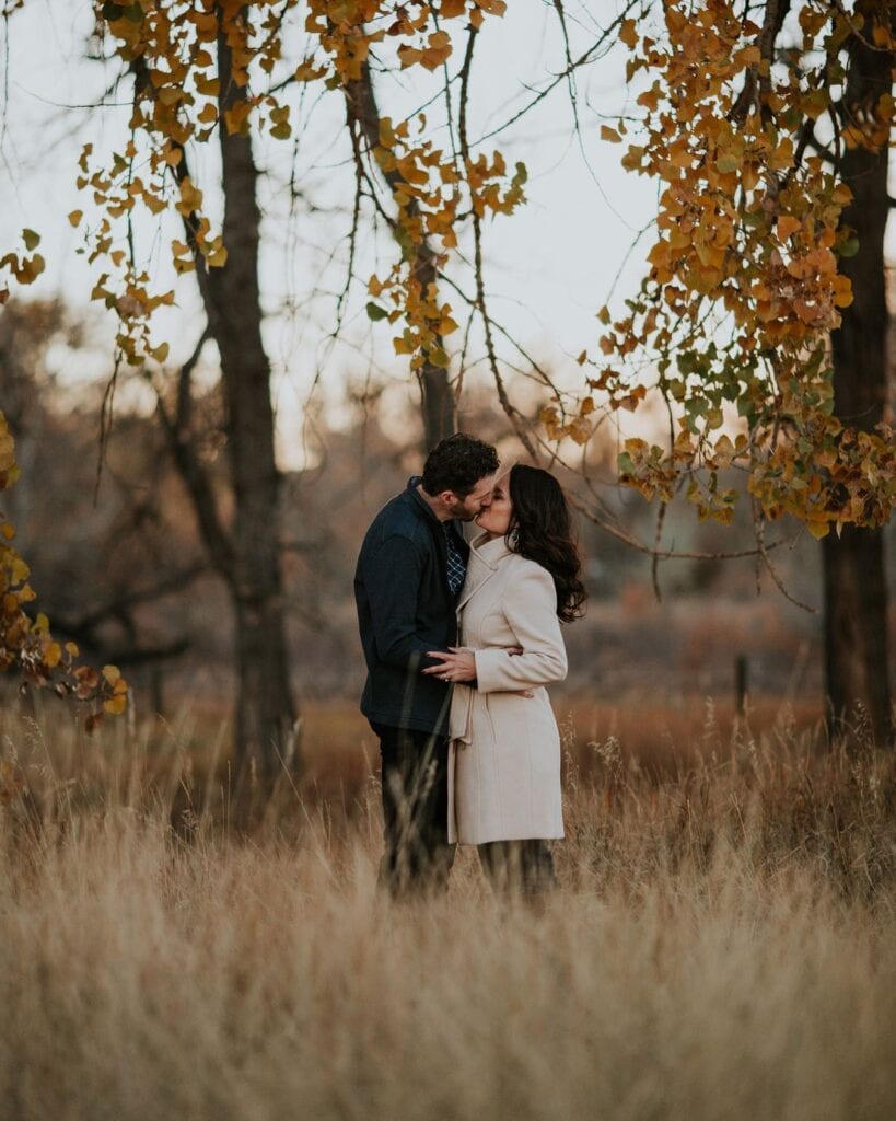 couple kissing in the fall